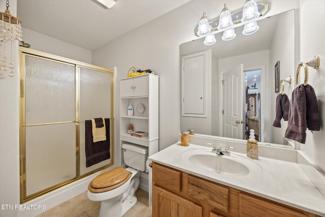 bathroom featuring tile patterned floors, a textured ceiling, an enclosed shower, toilet, and vanity