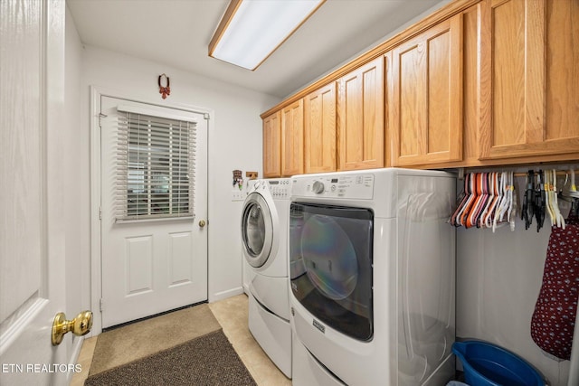 washroom with light tile patterned flooring, cabinets, and independent washer and dryer