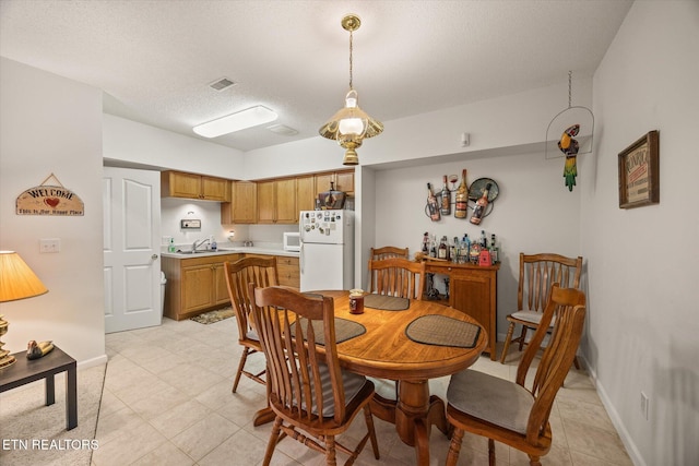 dining space with a textured ceiling