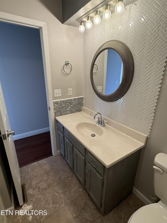 bathroom featuring tile patterned flooring, vanity, and toilet