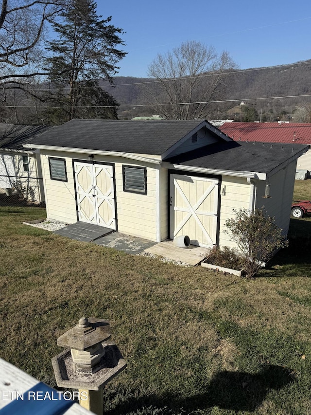 view of outbuilding featuring a yard