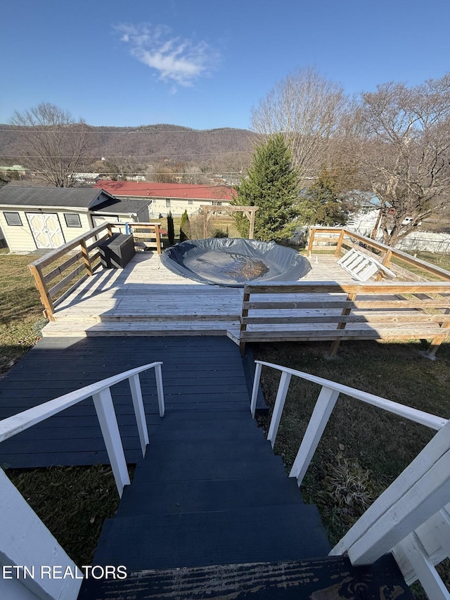 exterior space with a deck with mountain view