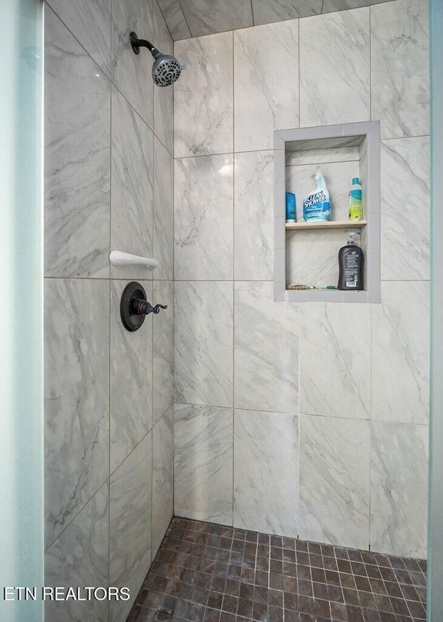 bathroom with tiled shower