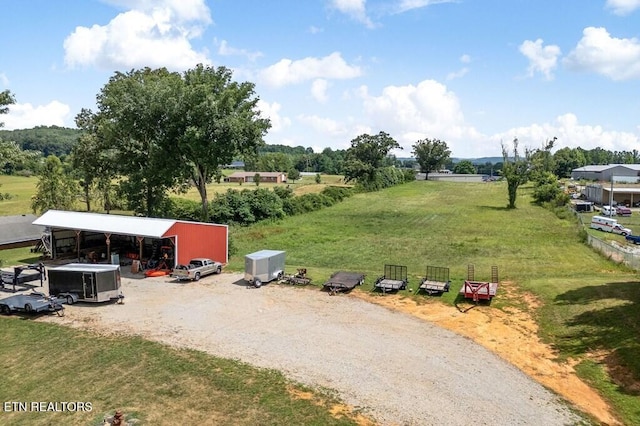 view of yard with an outbuilding and a rural view