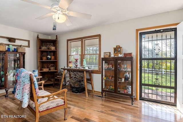 sitting room featuring light hardwood / wood-style flooring and ceiling fan