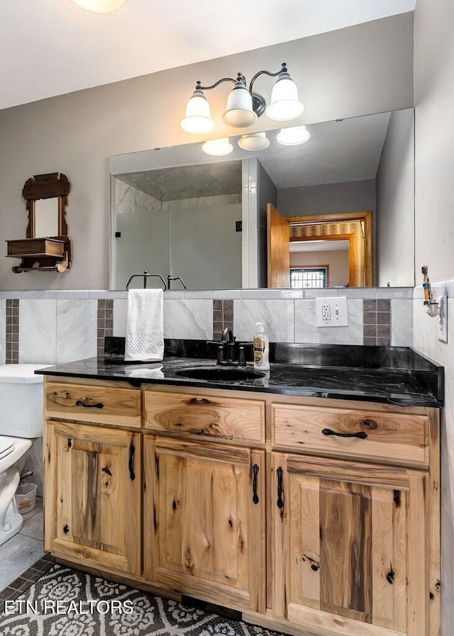 bathroom with decorative backsplash, vanity, toilet, and tile patterned flooring