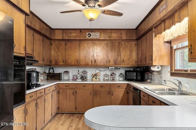 kitchen featuring ceiling fan, sink, range hood, light hardwood / wood-style floors, and black appliances