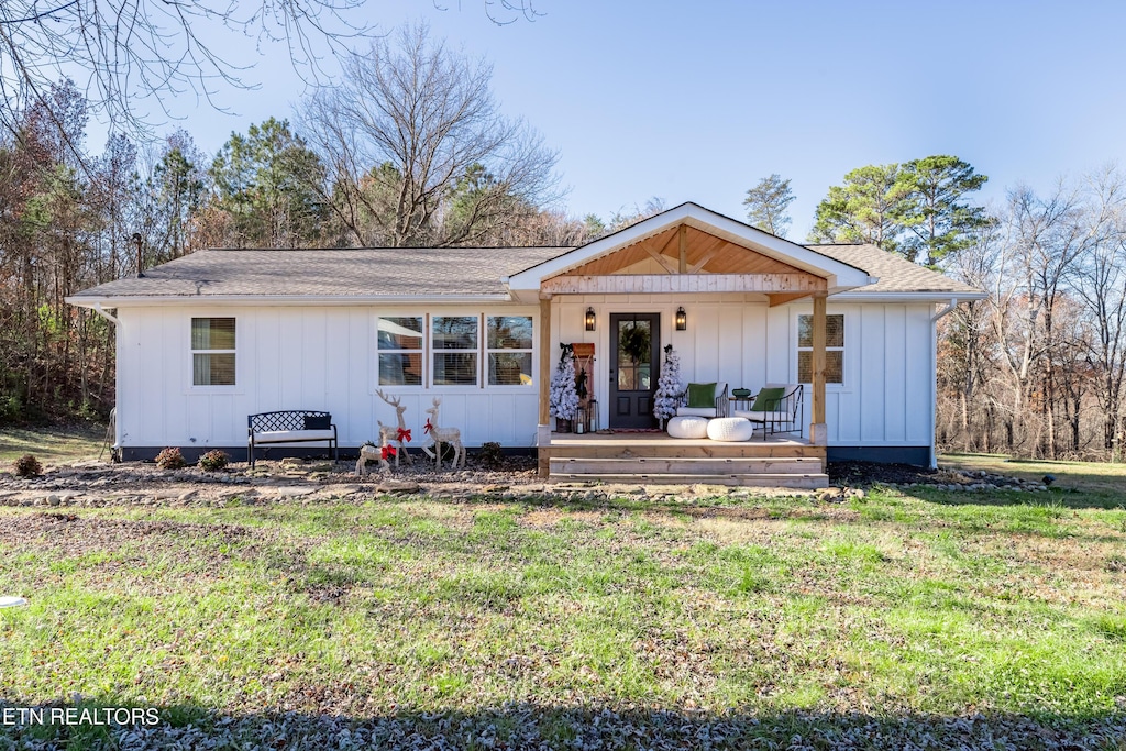 view of front of house with a front lawn and a porch