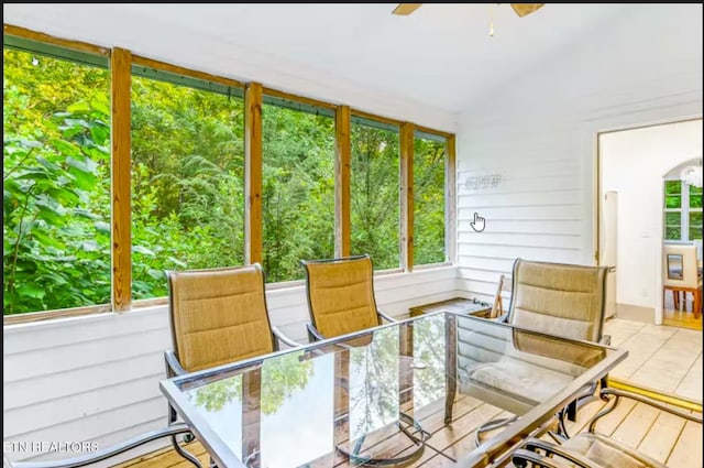 sunroom featuring ceiling fan