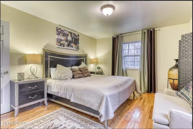 bedroom with hardwood / wood-style flooring