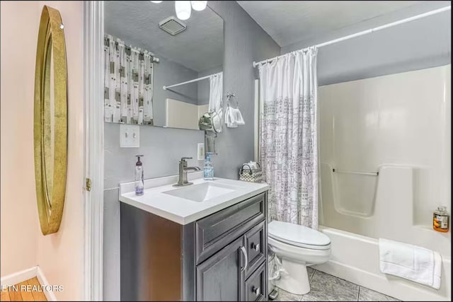 full bathroom with tile patterned floors, shower / bath combo, toilet, and vanity