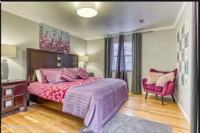 bedroom featuring wood-type flooring and ornamental molding