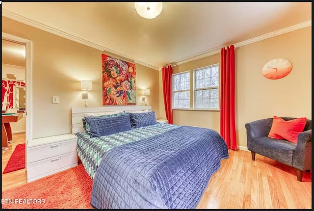 bedroom with light wood-type flooring and crown molding