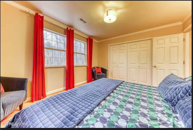 bedroom with a closet and crown molding