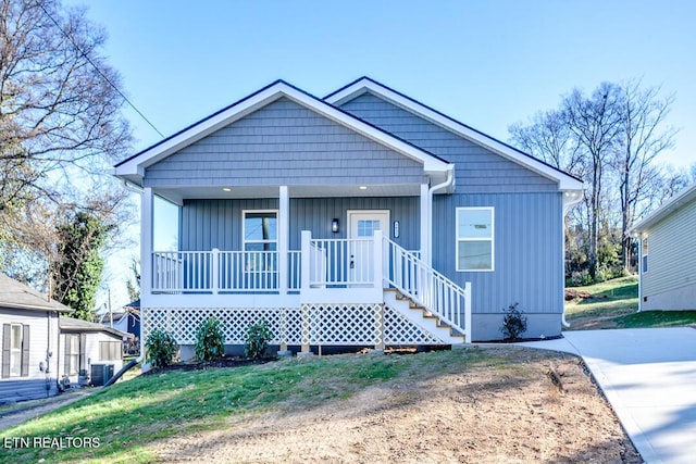 bungalow-style house featuring covered porch and cooling unit