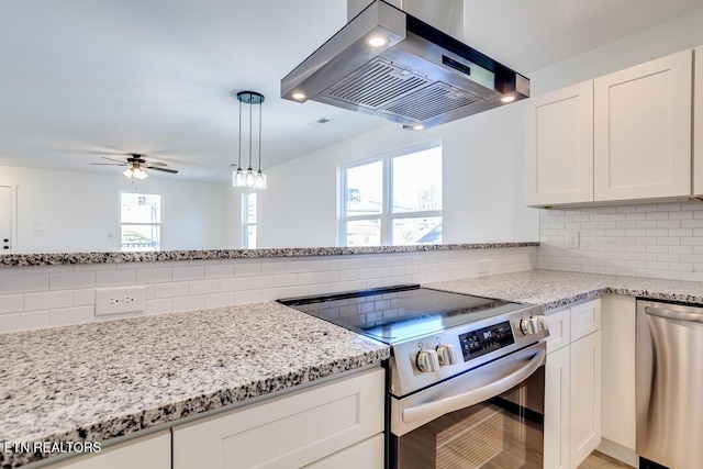 kitchen with backsplash, ceiling fan, white cabinetry, stainless steel appliances, and extractor fan