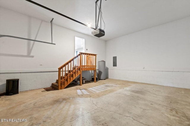 garage featuring electric panel, a garage door opener, and water heater