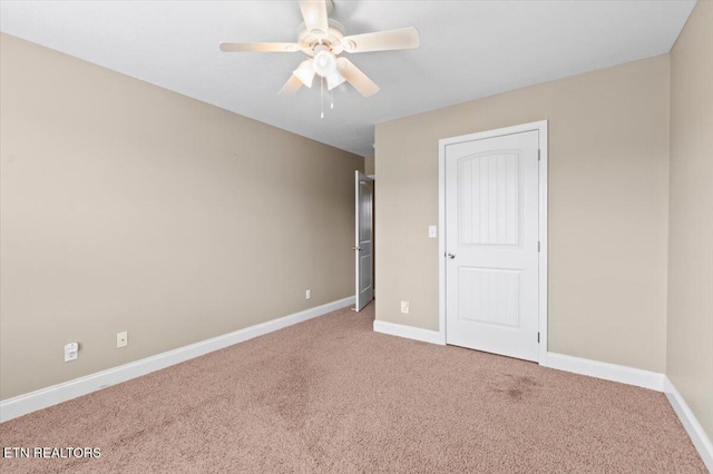 unfurnished bedroom with ceiling fan and carpet