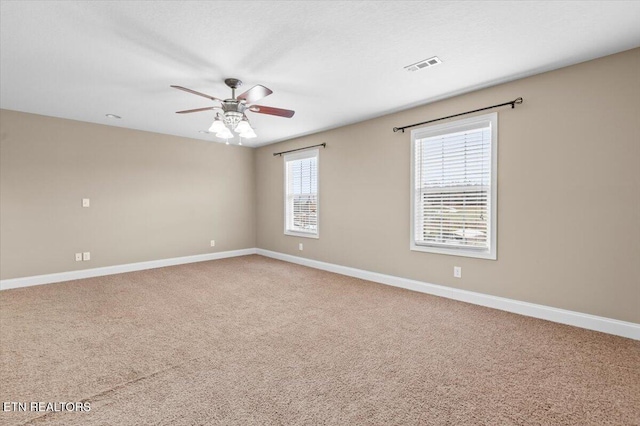 carpeted spare room with ceiling fan