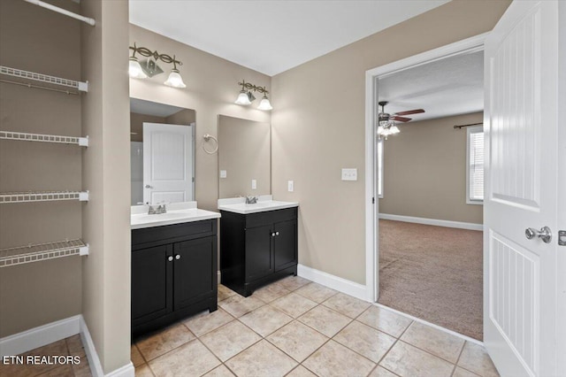 bathroom with ceiling fan, tile patterned flooring, and vanity