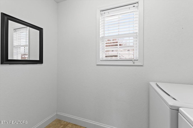 laundry area with tile patterned flooring and washer and dryer