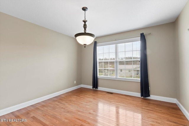 spare room featuring light hardwood / wood-style floors