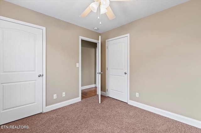 unfurnished bedroom featuring ceiling fan and carpet floors