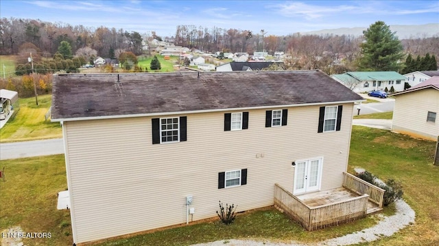 rear view of house with french doors and a yard