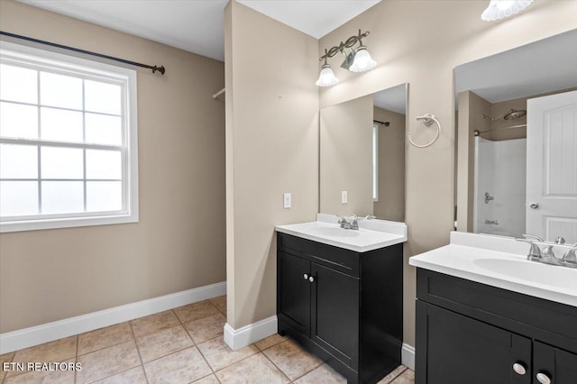 bathroom featuring tile patterned floors, a shower, and vanity