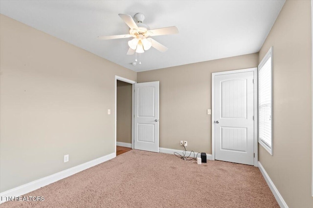 unfurnished bedroom featuring multiple windows, ceiling fan, and carpet floors