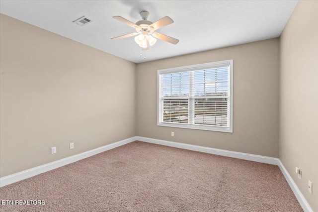 carpeted empty room featuring ceiling fan