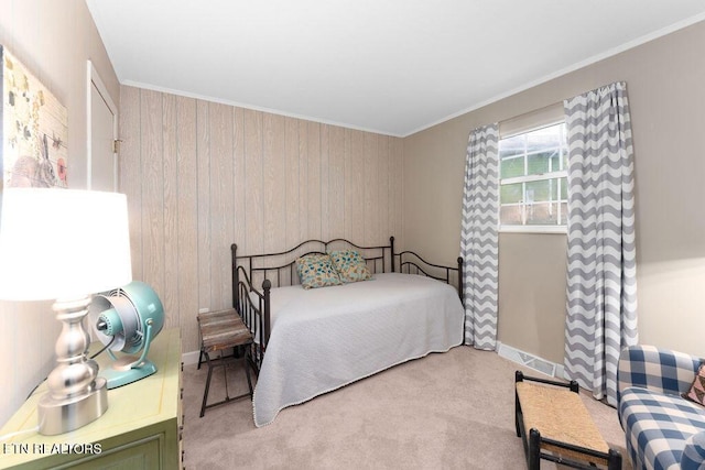 carpeted bedroom with wooden walls and ornamental molding