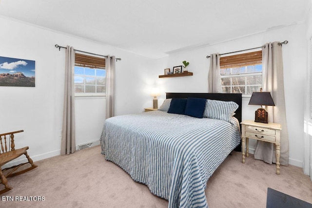 carpeted bedroom featuring multiple windows