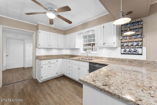 kitchen with white cabinets, hardwood / wood-style floors, dishwasher, and sink