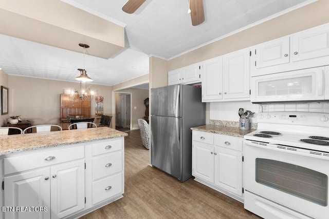 kitchen with white appliances, hanging light fixtures, tasteful backsplash, light hardwood / wood-style floors, and white cabinetry