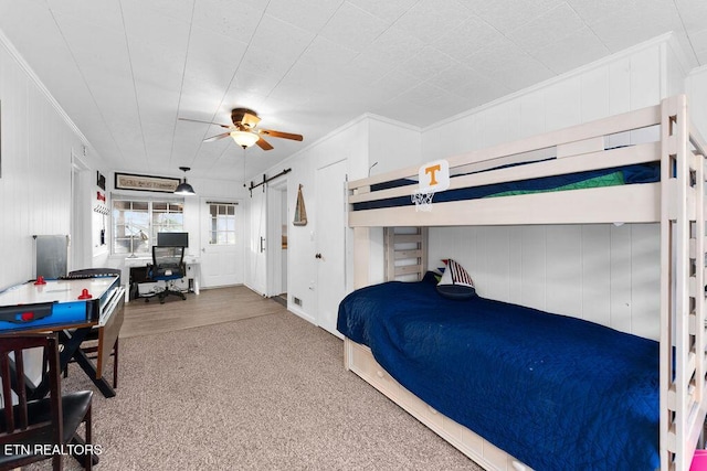 bedroom with ceiling fan, crown molding, and carpet floors