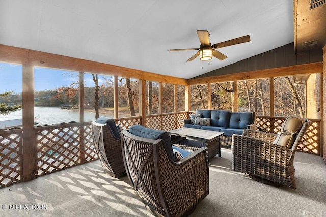 interior space with an outdoor living space, a water view, and ceiling fan