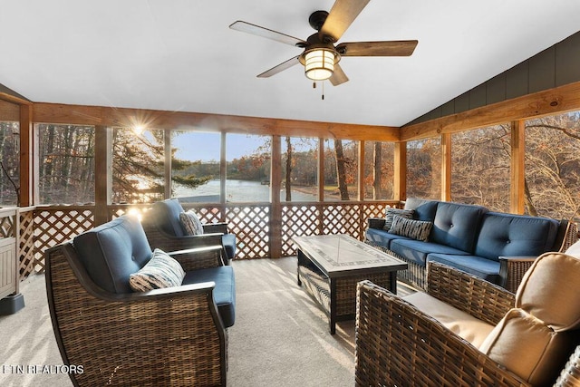 sunroom / solarium with a water view, ceiling fan, and lofted ceiling