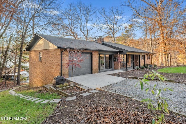 rear view of house featuring a garage