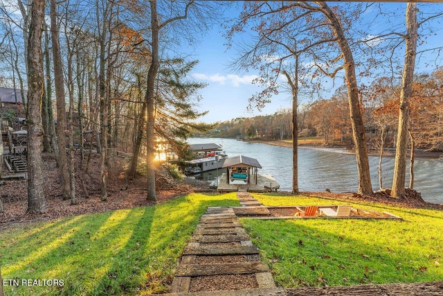 view of yard featuring a boat dock and a water view