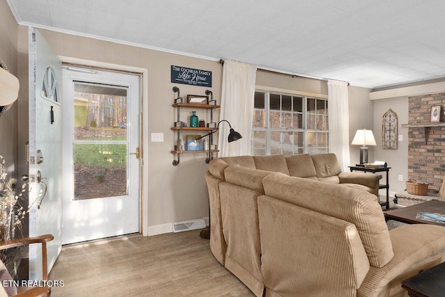 living room with hardwood / wood-style floors and ornamental molding