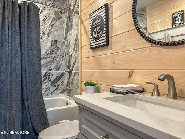 full bathroom featuring vanity, shower / bath combination with curtain, toilet, and wooden walls