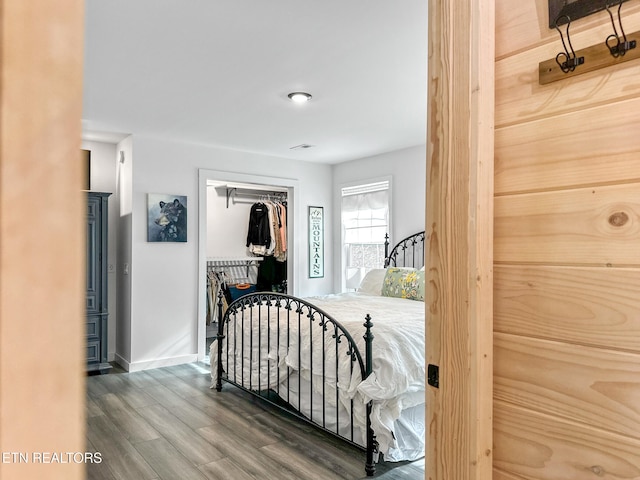 bedroom with a closet and hardwood / wood-style flooring