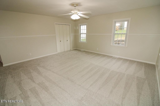 empty room with carpet and ceiling fan