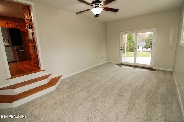 carpeted empty room with ceiling fan