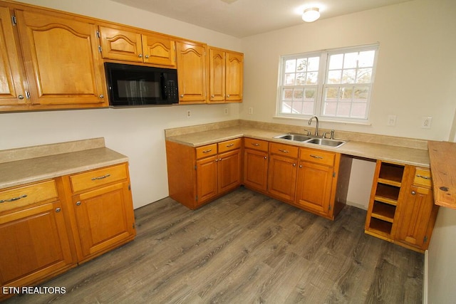 kitchen with dishwasher, dark wood-type flooring, and sink