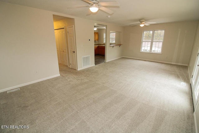 empty room with ceiling fan and light colored carpet