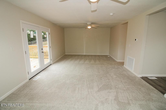 carpeted spare room with french doors and ceiling fan