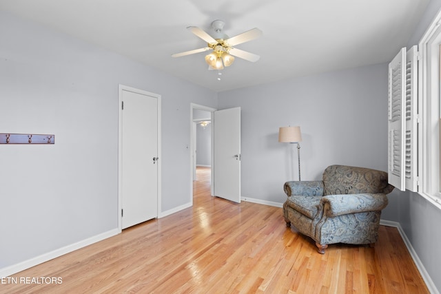 sitting room with light hardwood / wood-style floors and ceiling fan