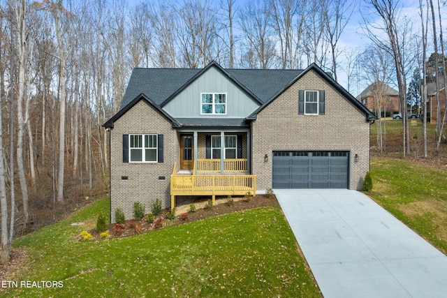 view of front of house featuring a porch, a front yard, and a garage